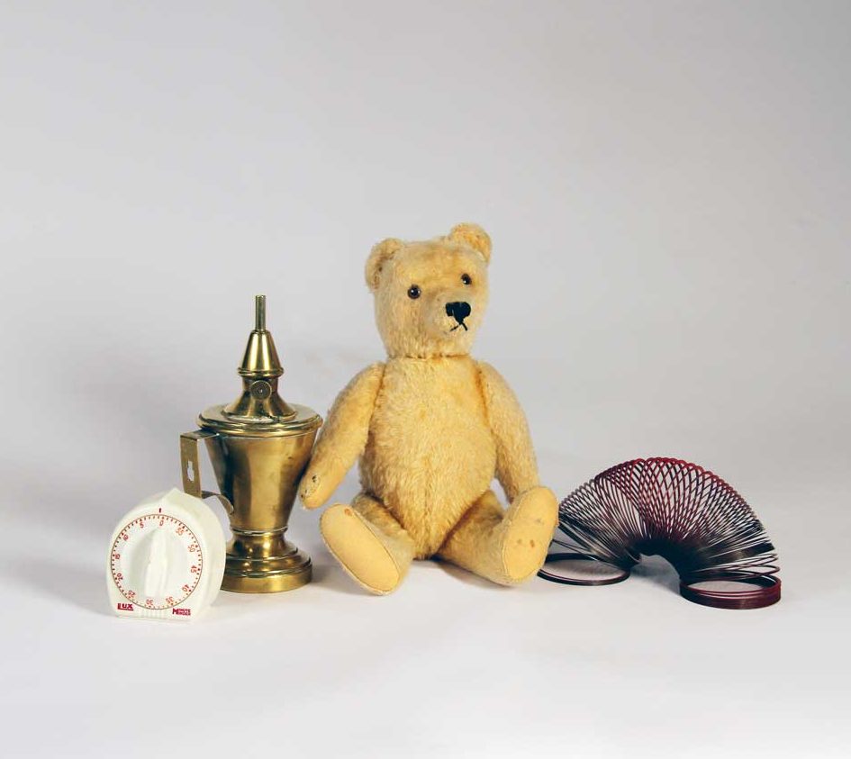 Kitchen timer, 1990s (Sally D. Liff); Whale oil lamp, c. 1810s; Teddy bear, 1930s (Cynthia Field); Slinky, 1960s. Photo by Museum staff.
