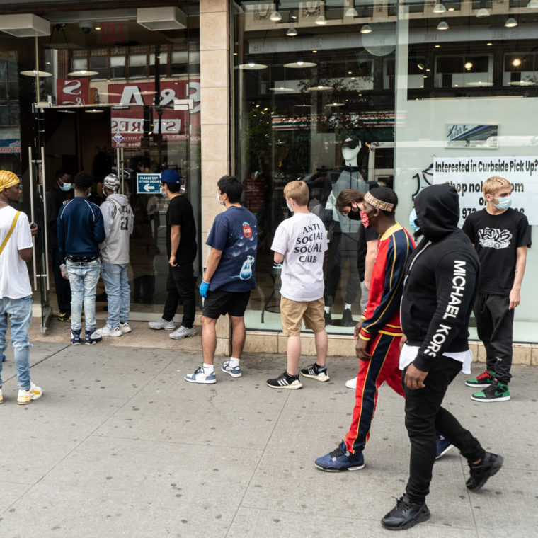 May 22, 2020: A Memorial Day sale brings white teens to Newark’s Four Corners for curbside pickup at the Nohble store, 795 Broad Street, Newark, New Jersey. © Camilo José Vergara 