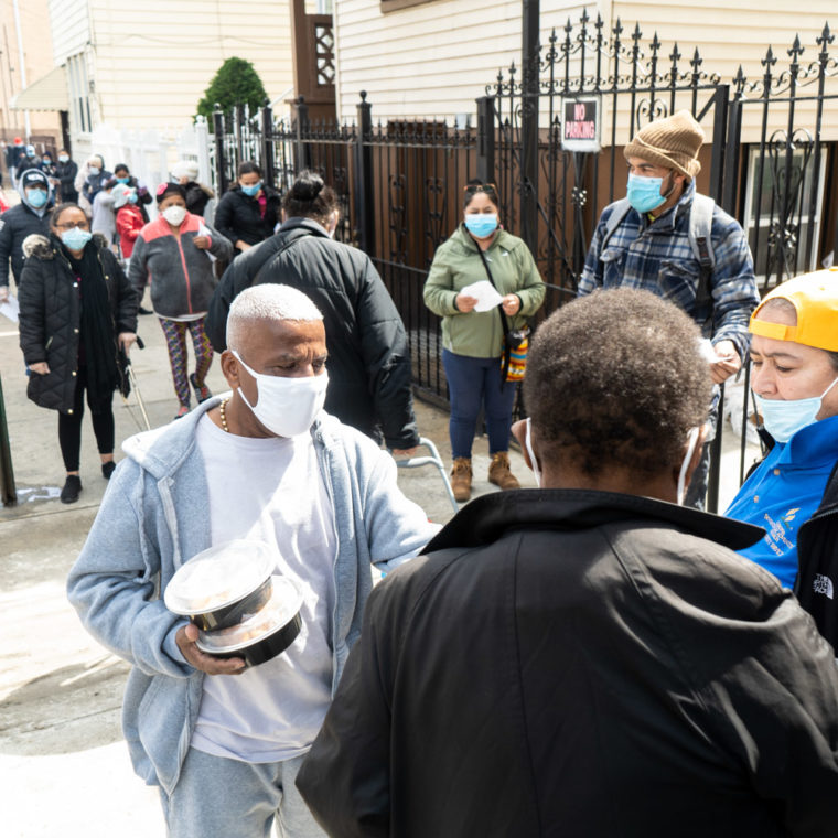 May 11, 2020: Food distribution outside the Corona Seventh-Day Adventist Church, 35-30 103rd Street, Corona, Queens, New York. A family of three receives food for three days, including a chicken, fruit, vegetables, cereal, and milk. © Camilo José Vergara 