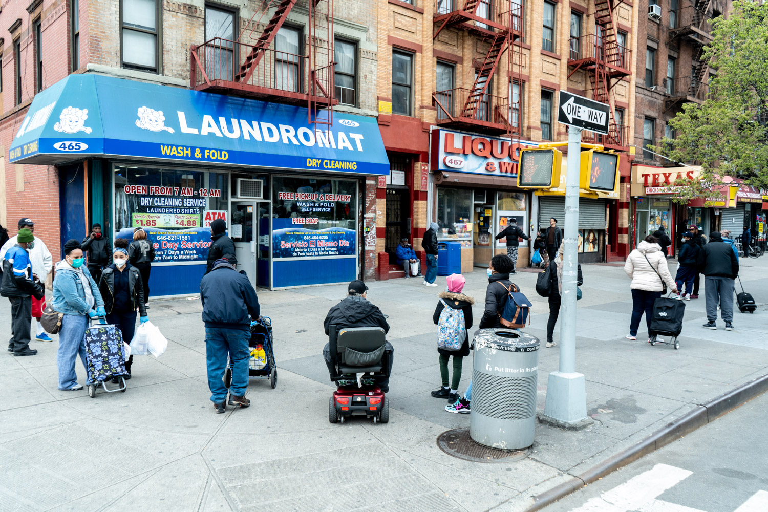 April 17, 2020: Waiting outside a laundromat at the corner of West 133rd Street and Malcolm X Boulevard, Harlem, New York, New York. © Camilo José Vergara