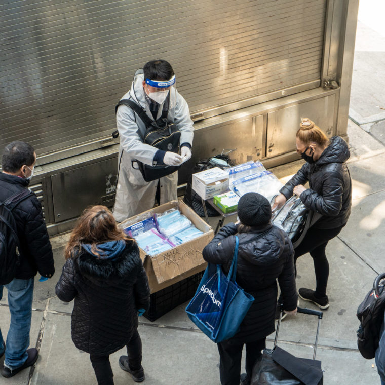 April 25, 2020: Street vendor selling masks and face shields in front of a closed kiosk, 61st Street at Roosevelt Avenue, Queens, New York. © Camilo José Vergara 
