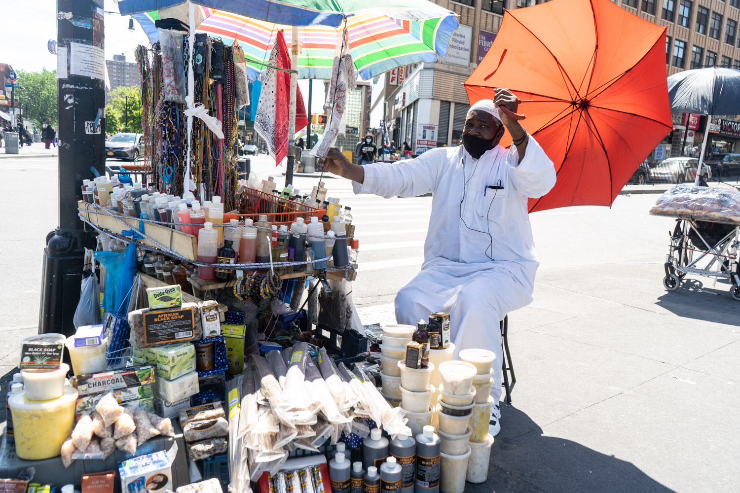 May 25, 2020: Street vendor selling African and West Indian imports, Third Avenue at East 149th Street, Bronx, New York. © Camilo José Vergara