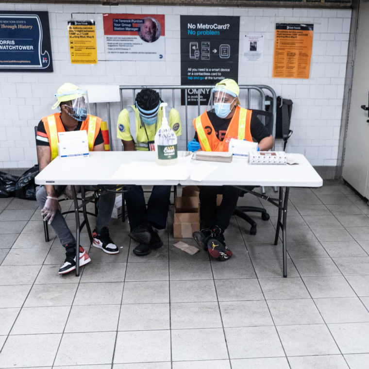 June 9, 2020: Transit workers offering free hand sanitizer and masks at the 125th Street Station at Lexington Avenue in Harlem, New York, New York. © Camilo José Vergara 