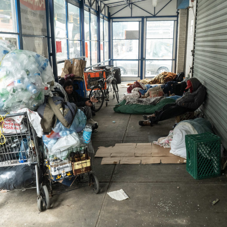 April 29, 2020: Homeless men and their shopping carts find shelter in a former discount store entryway, 78th Street at Roosevelt Avenue, Queens, New York. © Camilo José Vergara 