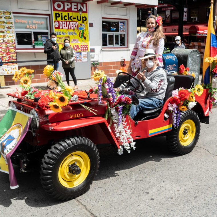 May 24, 2020: To advertise their restaurant over Memorial Day weekend, this couple celebrates their Colombian heritage in a decorated Jeep, 81-01 Roosevelt Avenue, Queens, New York. © Camilo José Vergara 