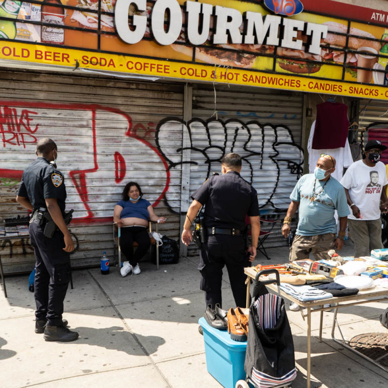 July 15, 2020: After the Gourmet Deli closed, street vendors set up their tables on the sidewalk. Washington Avenue at East Tremont Avenue, Bronx, New York. © Camilo José Vergara 