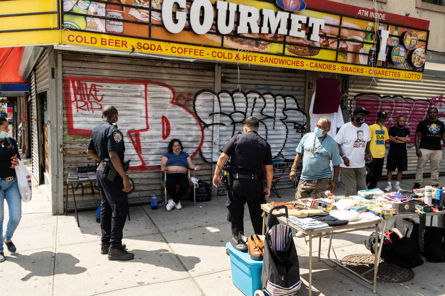 July 15, 2020: After the Gourmet Deli closed, street vendors set up their tables on the sidewalk. Washington Avenue at East Tremont Avenue, Bronx, New York. © Camilo José Vergara