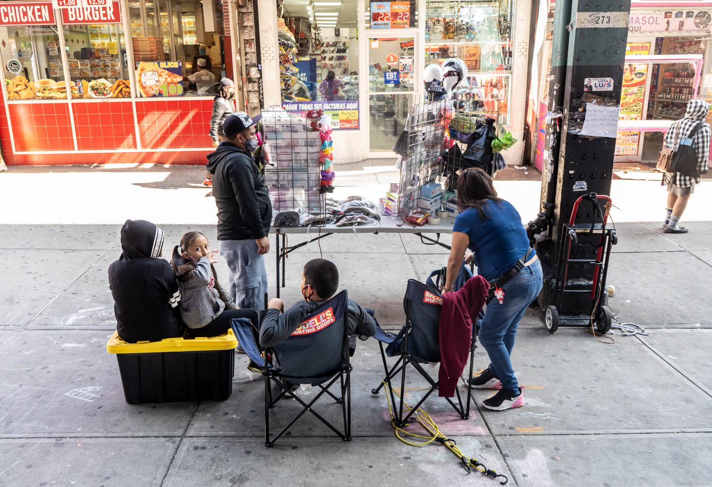 September 21, 2020: Street vendors and their children selling PPE and articles of clothing. 2278 Jerome Avenue, Bronx, New York. © Camilo José Vergara