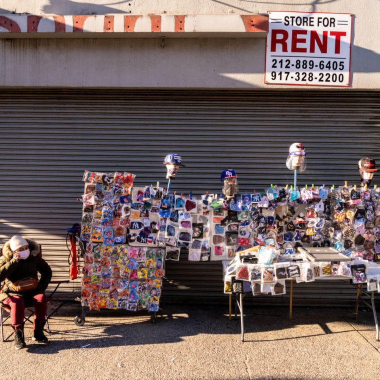 November 18, 2020: Street vendor sells PPE in front of a former Sprint store. 2063 Third Avenue, Bronx, New York. © Camilo José Vergara 