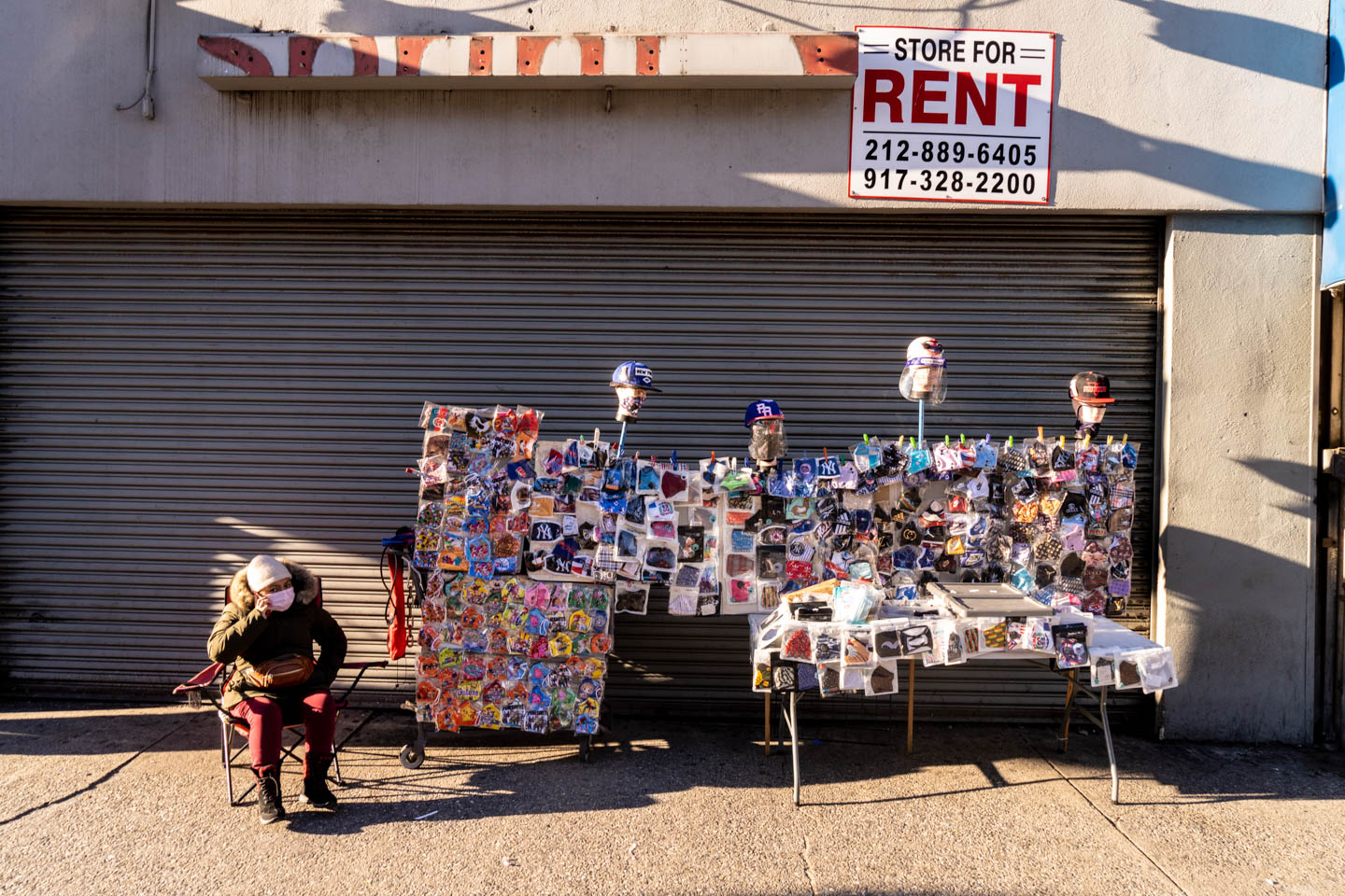 November 18, 2020: Street vendor sells PPE in front of a former Sprint store. 2063 Third Avenue, Bronx, New York. © Camilo José Vergara