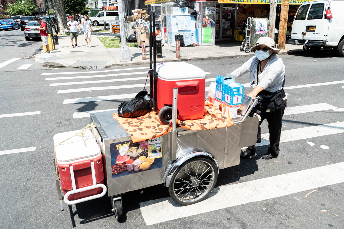 July 25, 2020: Maria, originally from Ecuador, on her way to her spot to sell Italian ices. 37th Avenue at 99th Street, Queens, New York. © Camilo José Vergara