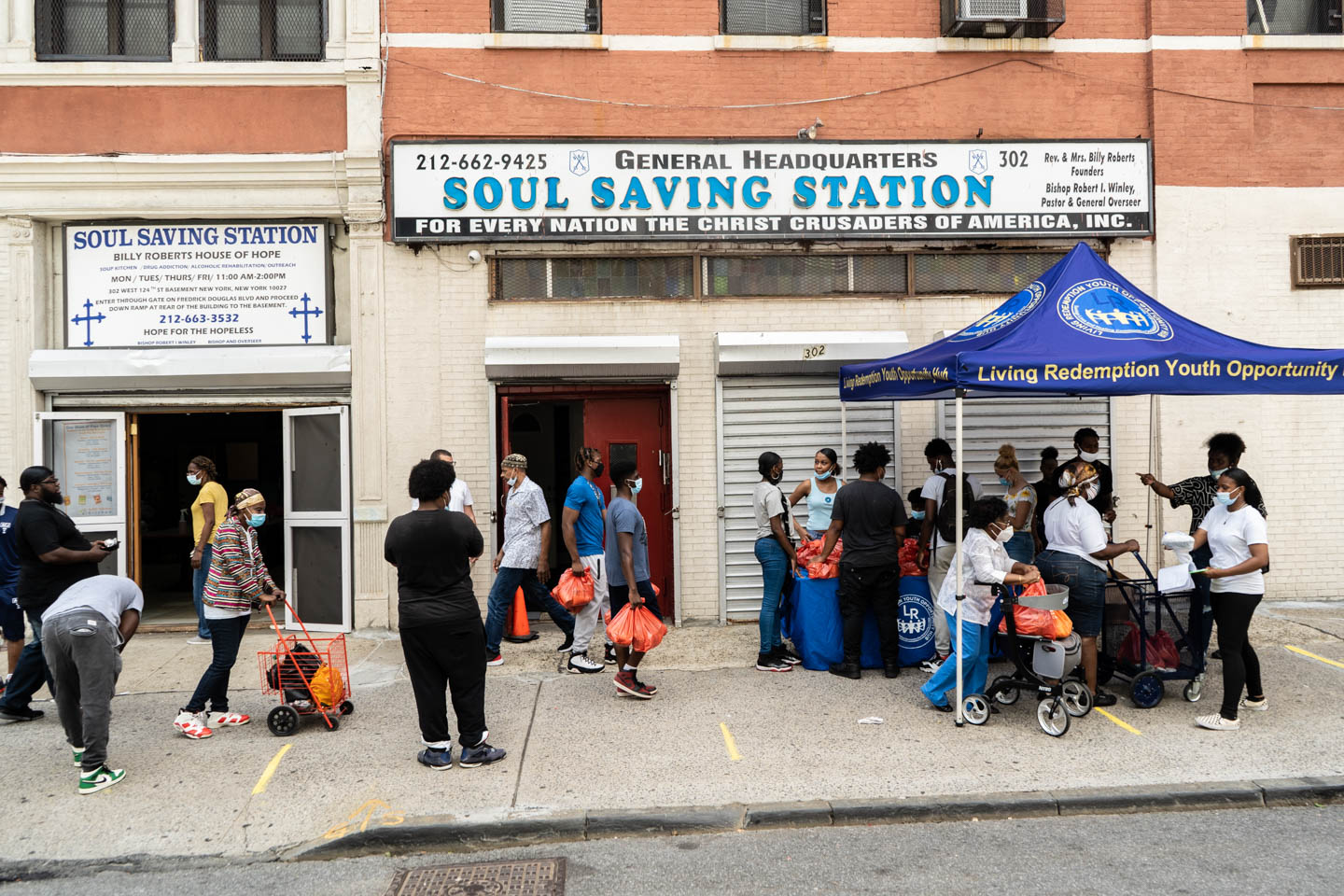 August 28, 2020: Soul Saving Station Headquarters. The organization gives away free food to people that come or sends volunteers with free food to people unable to come and pick it up. 302 West 124th Street, Harlem, New York, New York. © Camilo José Vergara