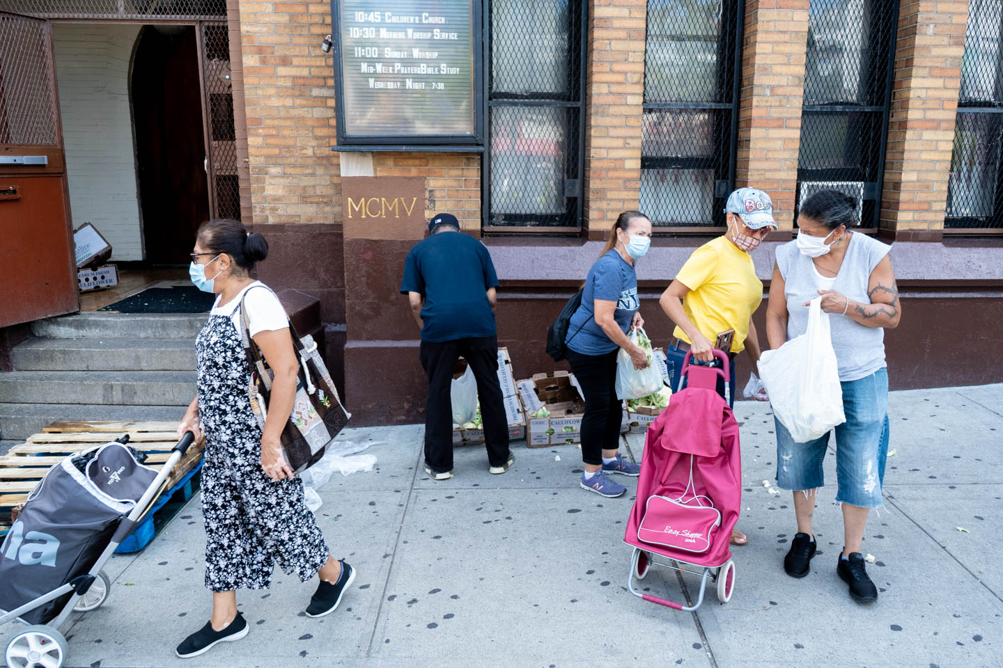 September 3, 2020: People helping themselves to left over cauliflower, broccoli, and cabbage. Creston Avenue Baptist Church, 114 East 188th Street, Bronx, New York. © Camilo José Vergara