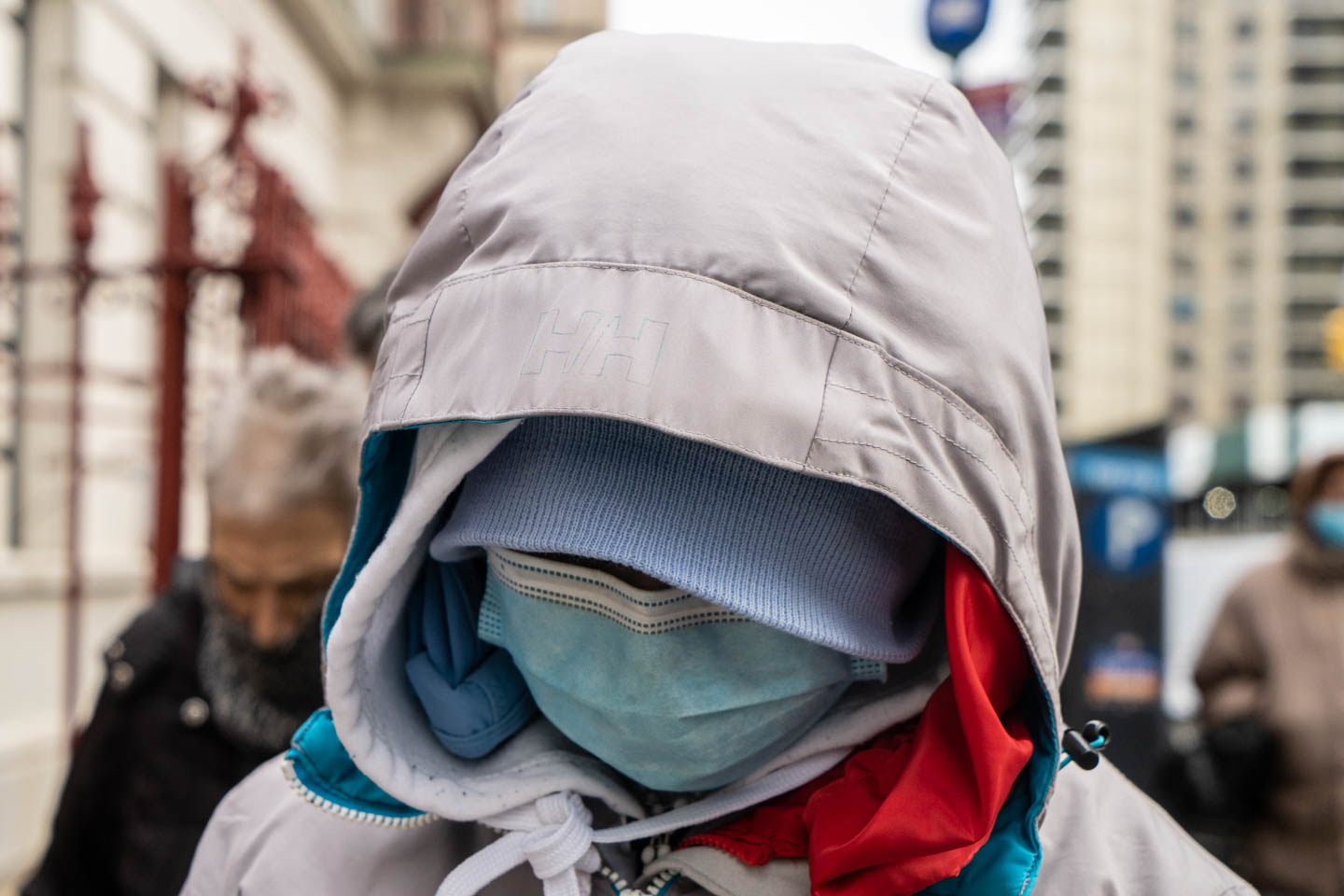 November 17, 2020: Masked person waiting for free food. International Pentecostal Church on West 179th Street, New York, New York. © Camilo José Vergara