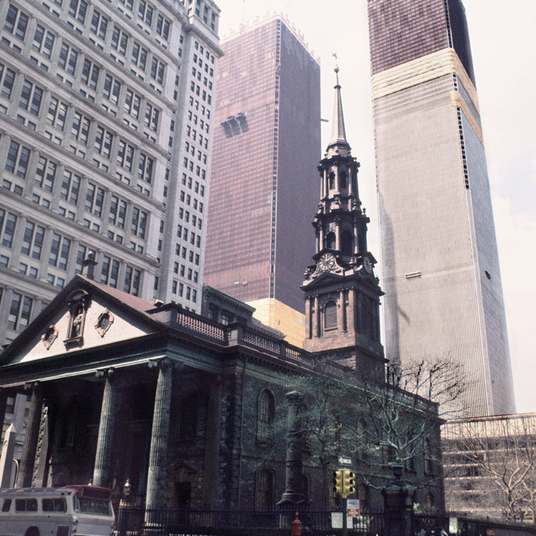 View west from St. Paul's Chapel with the Twin Towers under construction, Broadway and Fulton Street, New York, New York; 1970. 