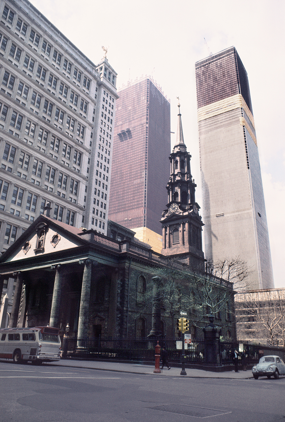 View west from St. Paul's Chapel with the Twin Towers under construction, Broadway and Fulton Street, New York, New York; 1970.